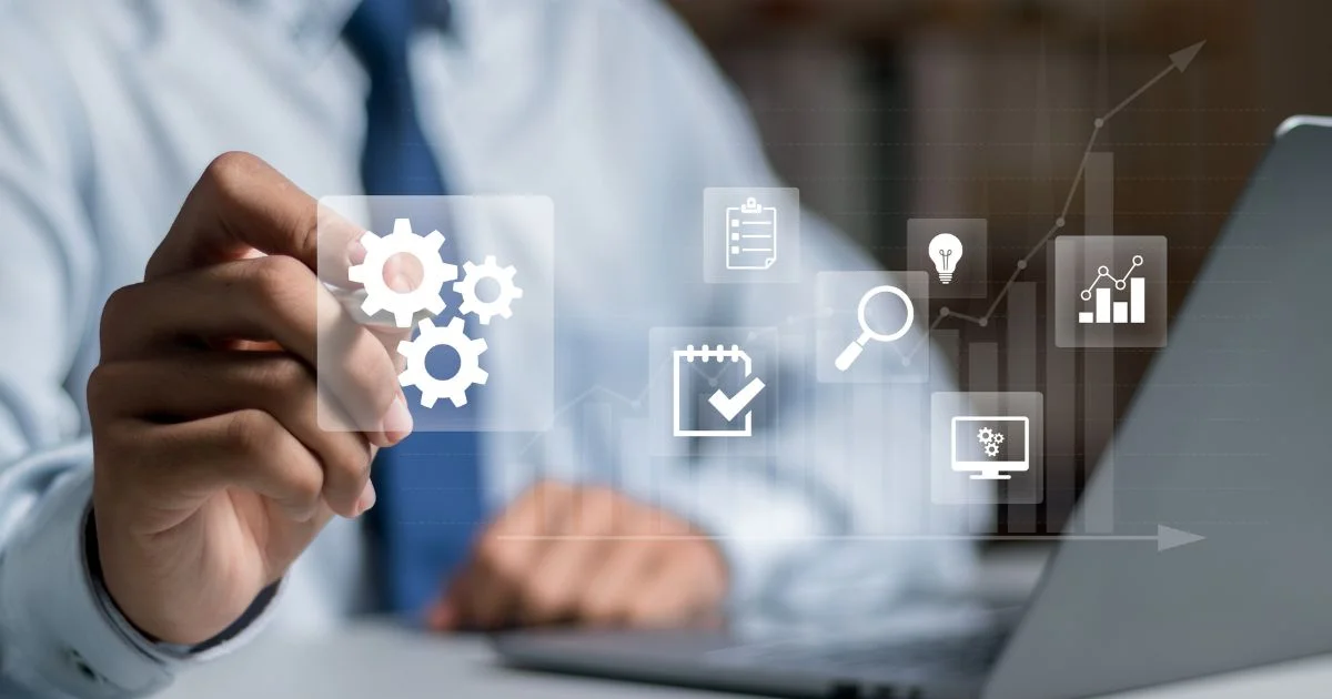 A businessman pointing at virtual gear icons on a transparent screen